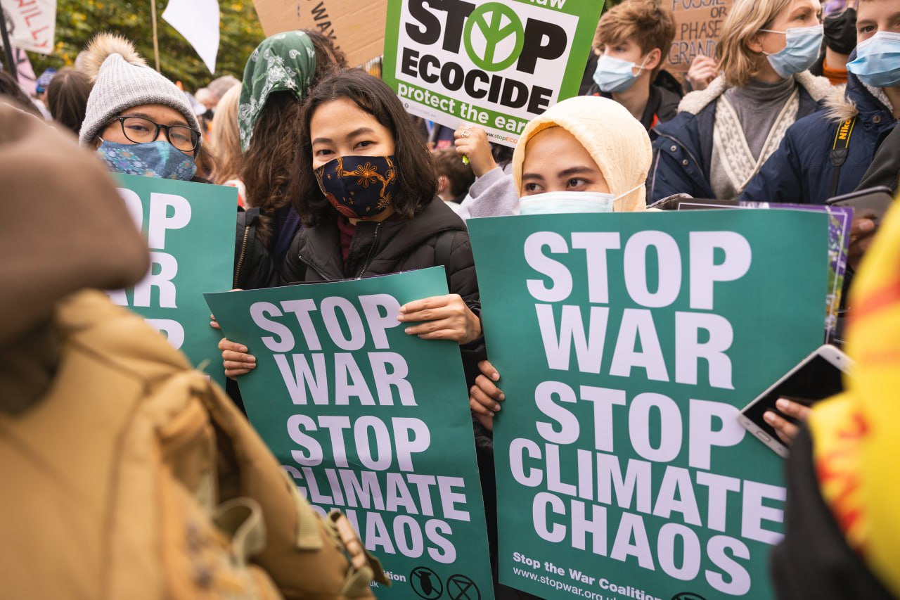 Protesters holding a 'stop war' posters